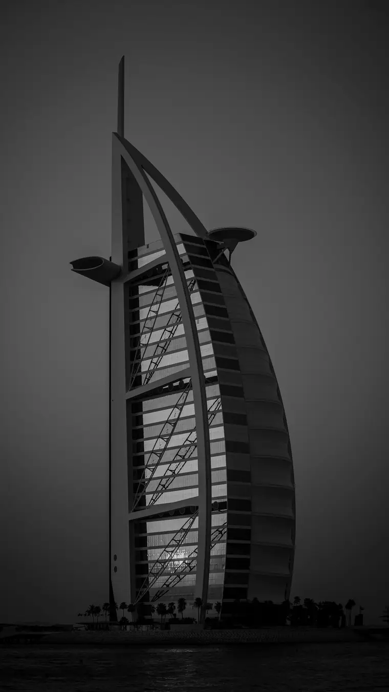 The Burj Al Arab at dusk, in black and white.