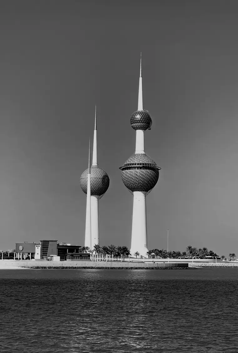 The Kuwait Towers at dusk, in black and white.